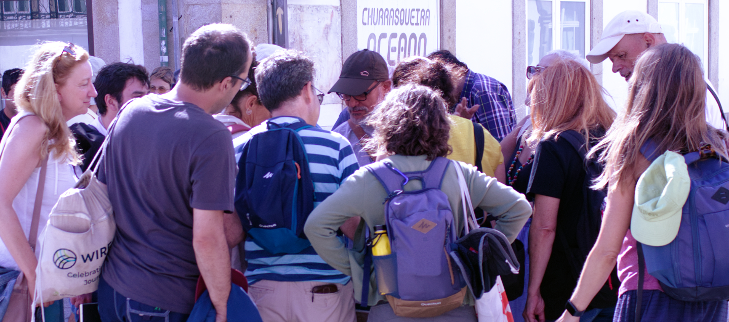 Camilo Saraiva surrounded by other urban sketchers in Porto while showing his sketchbook at one of the meetings.